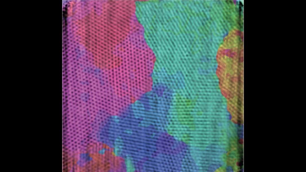 Closeup, showcasing colorful areas of magenta, violet, red, aqua, blue, orange, yellow, and green.