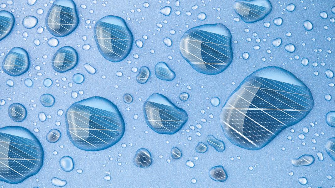 Closeup of droplets on blue background reflecting grids.